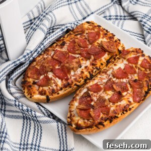 french bread pizza made in the air fryer and served on a white plate.