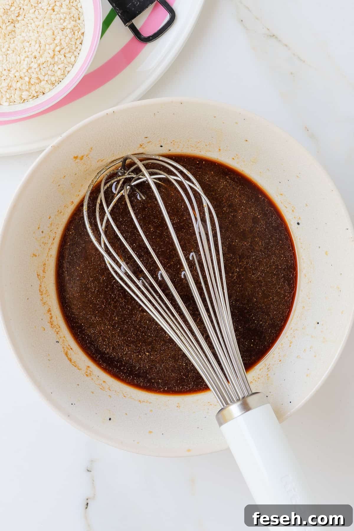 Teriyaki sauce being whisked in a bowl.