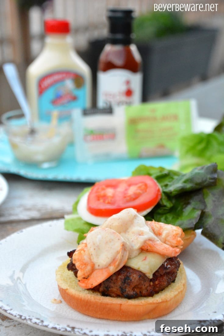 Cajun pork burger topped with shrimp and Cajun aioli