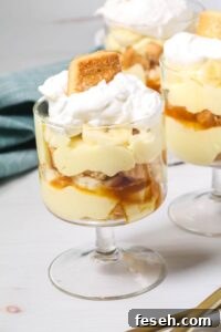 Chocolate Peanut Butter Banana Smoothie Recipe for Creamy Energy 6 An easy banana pudding delight: a glass dessert cup layered with creamy pudding, banana slices, caramel sauce, and fluffy whipped cream, all crowned with a cookie.
