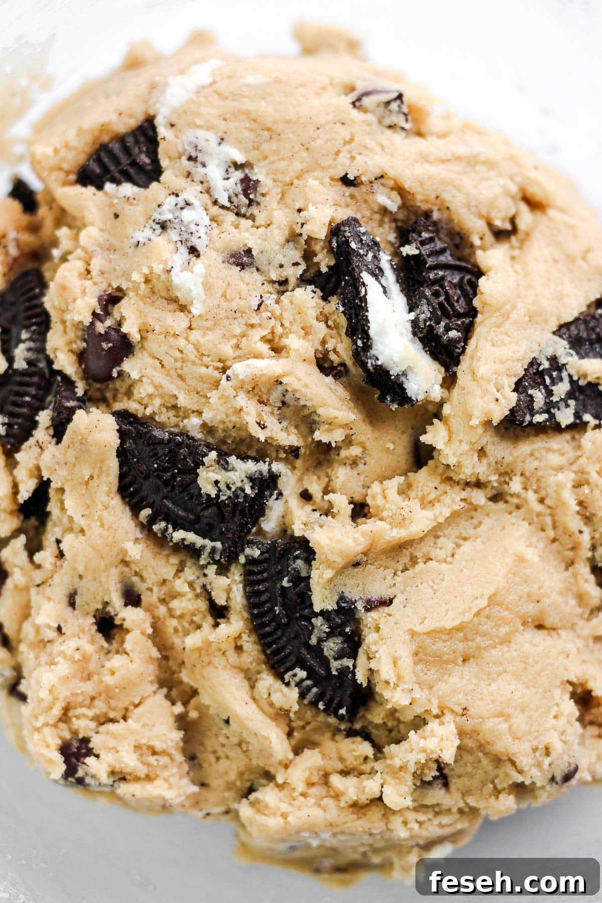 Folding crushed Oreos into dough