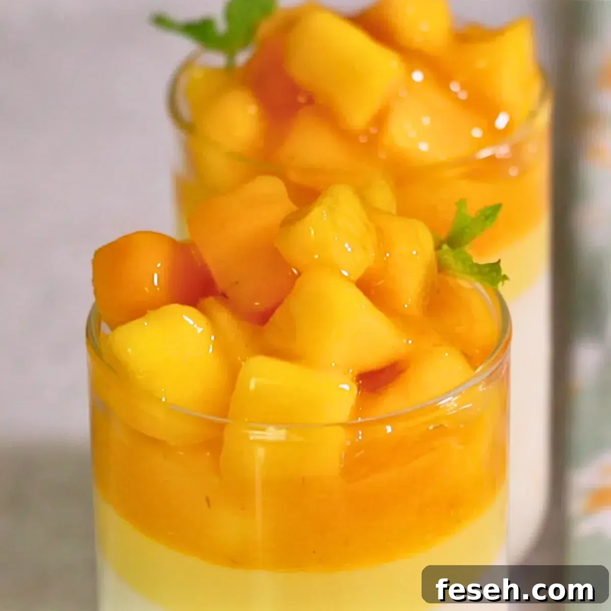 mango panna cotta with melty mango topping in glasses