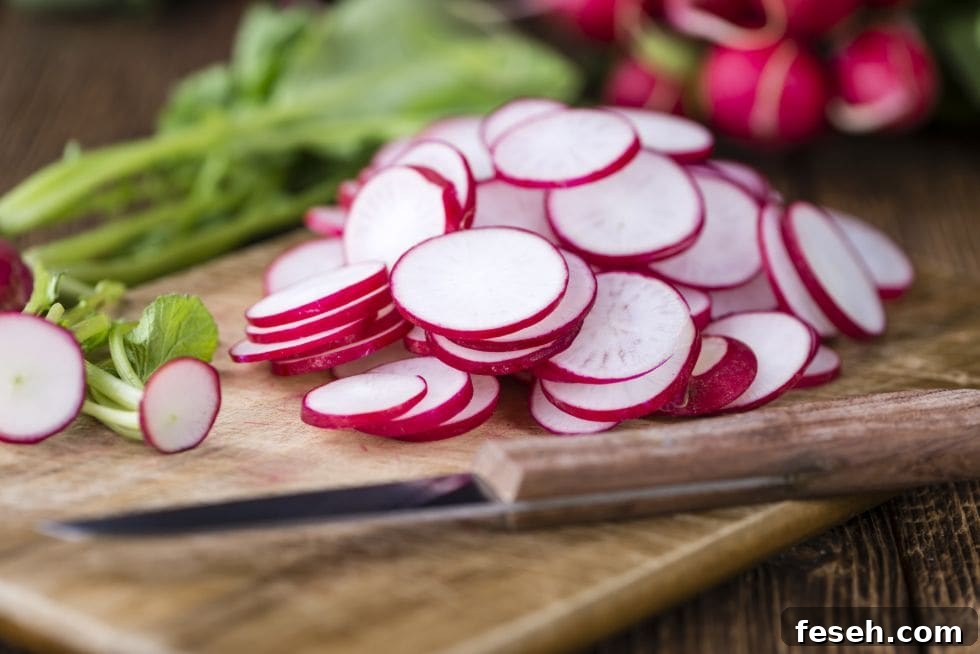 crunchy keto snacks with radishes sliced up on a cutting board next to a kife