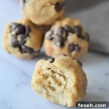 No bake energy bites, one with a bite taken out of it.