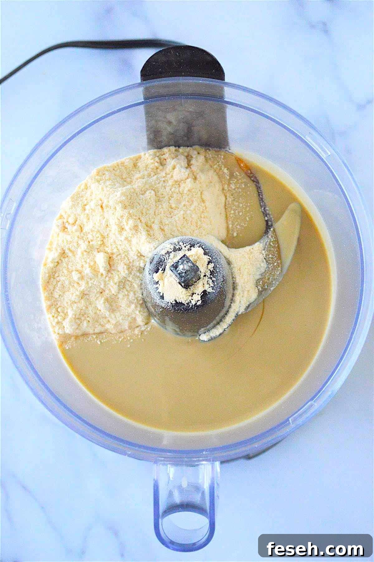 Tahini, honey, and coconut flour in a food processor.