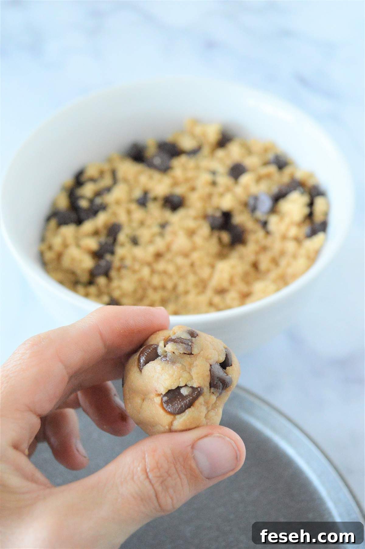 A process image showing how to roll no bake energy bites into balls.