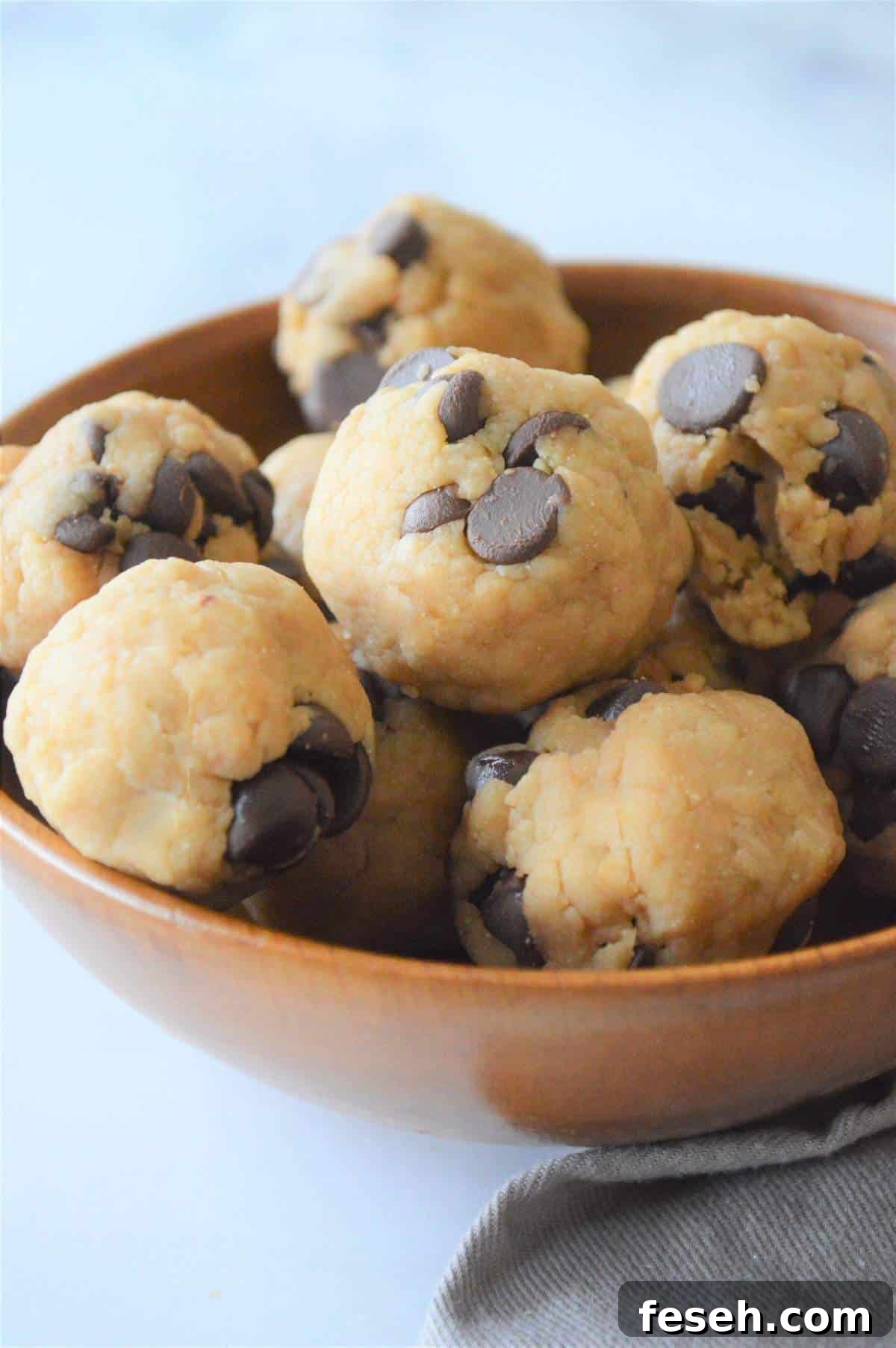 A bowl of no bake cookie dough energy bites.