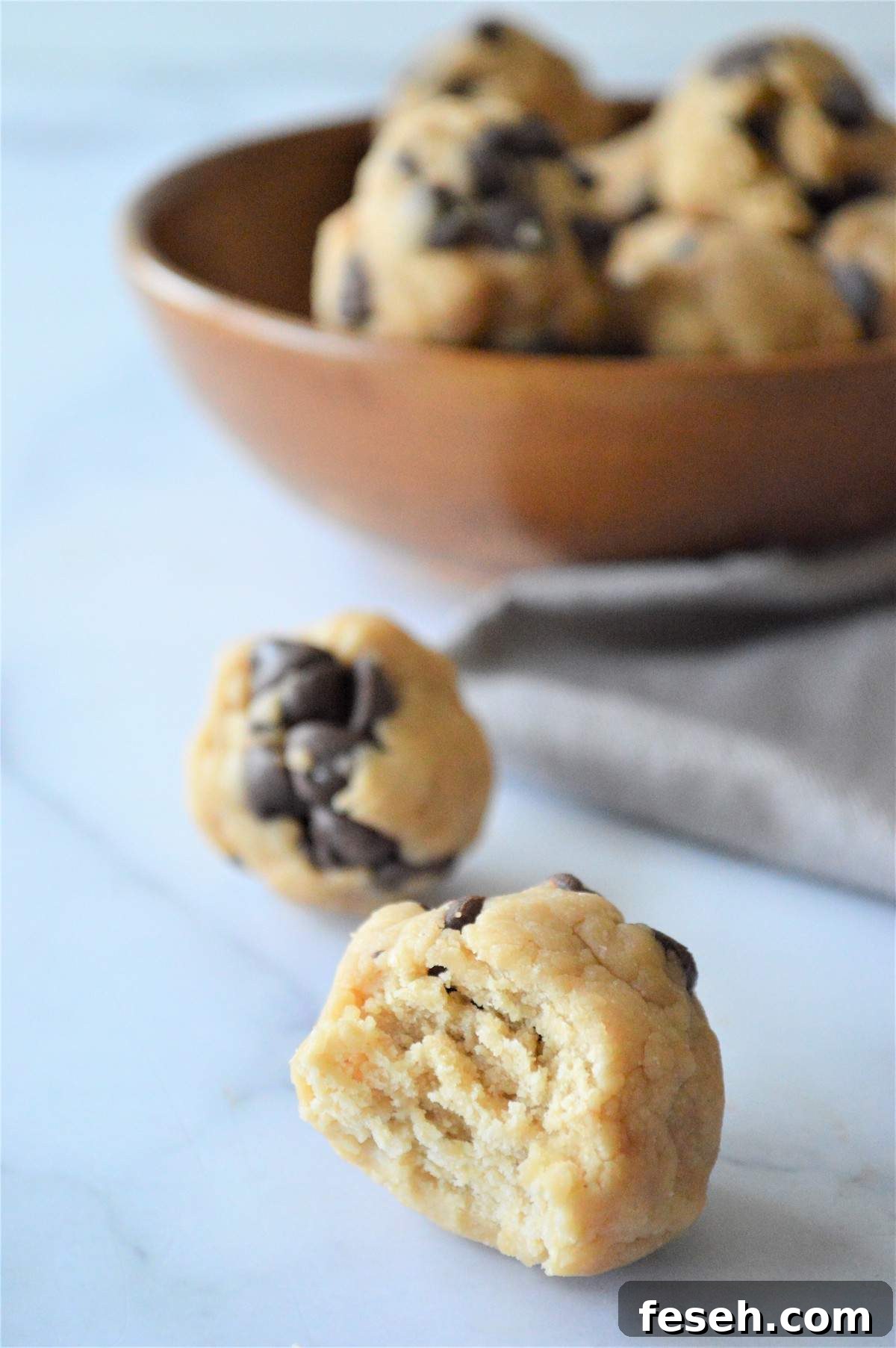 No bake energy bites in front of a bowl of no bake energy bites.