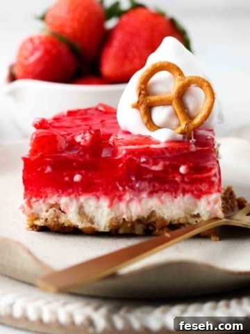 dairy free strawberry pretzel salad on a plate with whipped cream on top