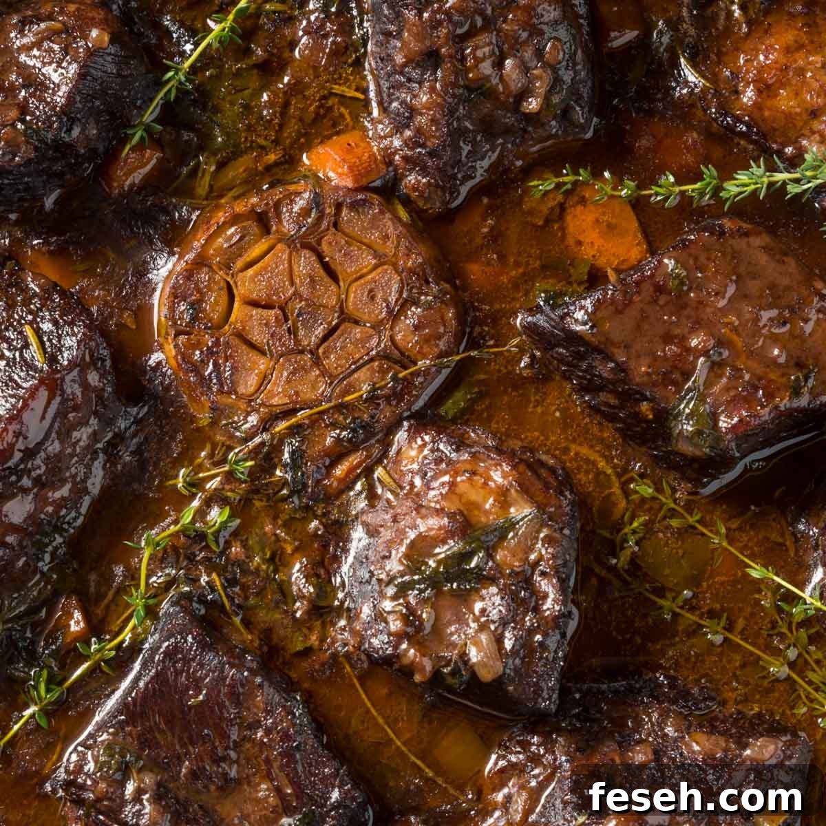 a closeup of a pot of braised beef short ribs just out of the oven