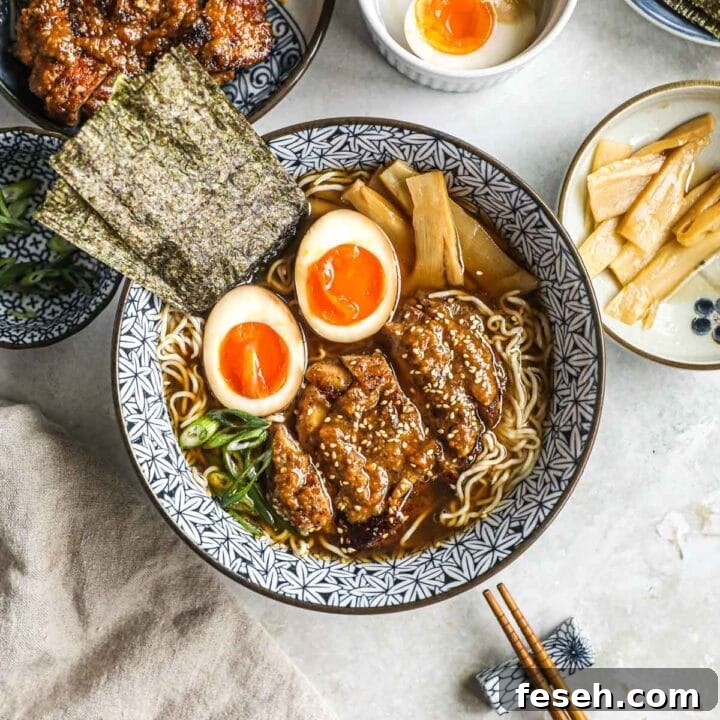 Gluten-free tofu shirataki ramen with miso chicken thighs in blue Japanese bowls with ajitama (ramen egg), nori, green onions, and menma (pickled bamboo shoots).