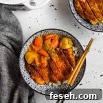 Chicken Katsu Curry in a blue Japanese porcelain bowl with blue and wood bamboo chopsticks and a white Le Creuset dutch oven