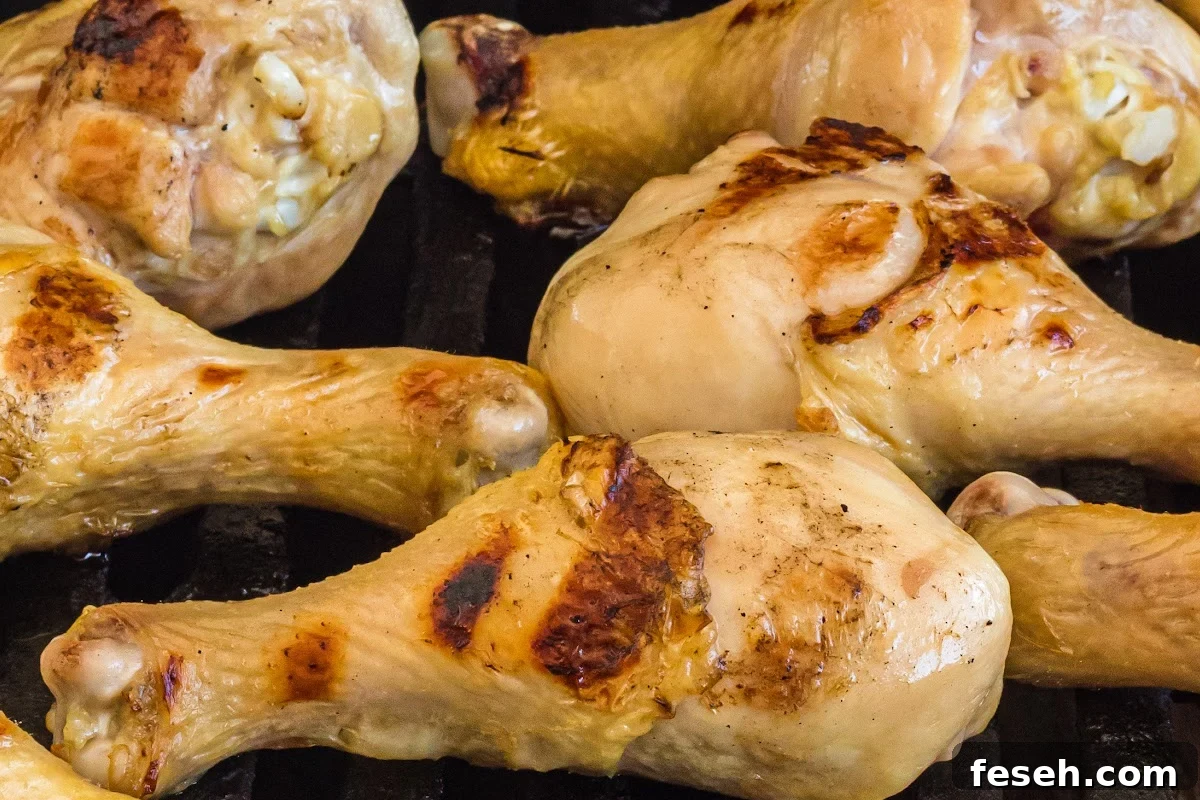 chicken drumsticks on grill with some char marks.