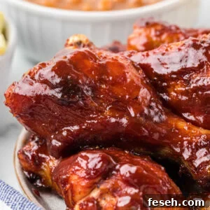 close up of chicken drumstick covered in barbecue sauce.