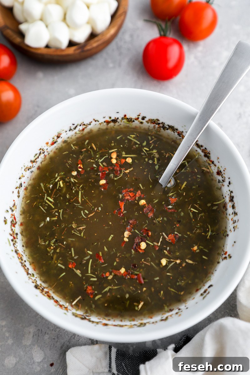 A small white bowl filled with spicy Italian vinaigrette