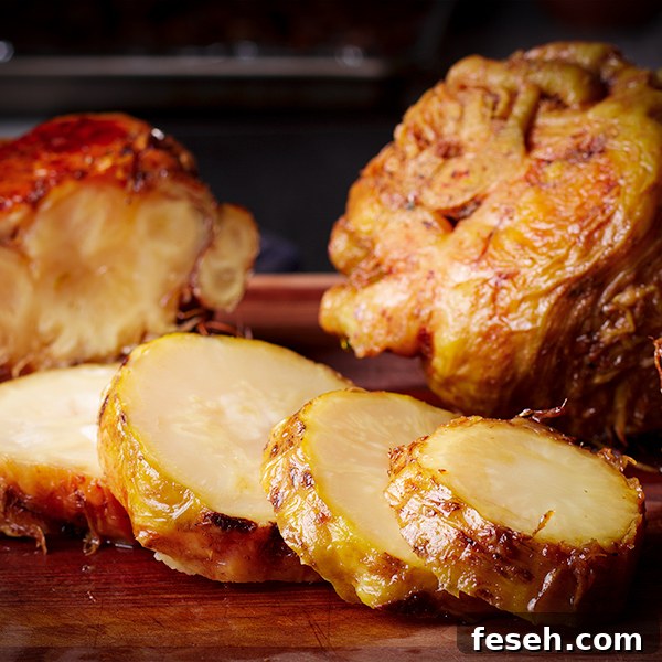 Slices of a whole roasted celery root on a cutting board.