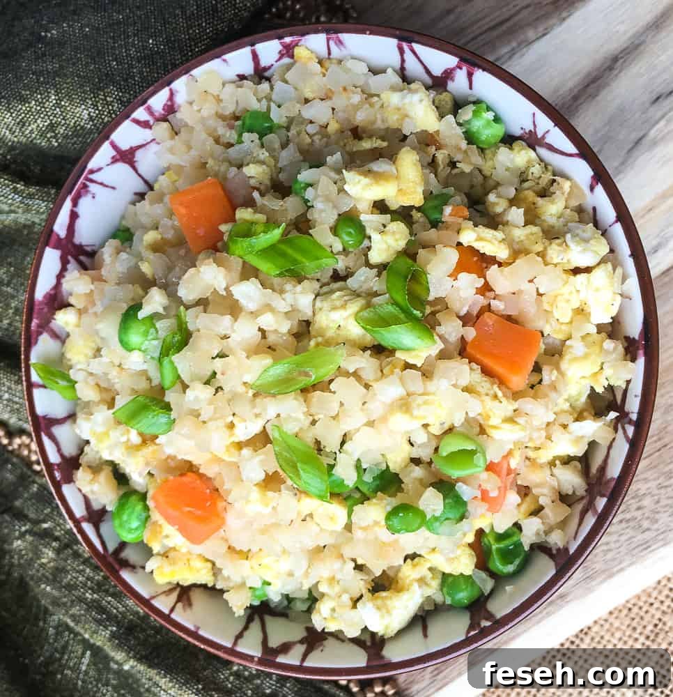 Low Carb Cauliflower Fried Rice in brown and white ceramic bowl