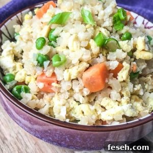The finished Cauliflower Fried Rice served in a ceramic bowl