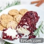 A goat cheese log with dried cranberries and cinnamon.
