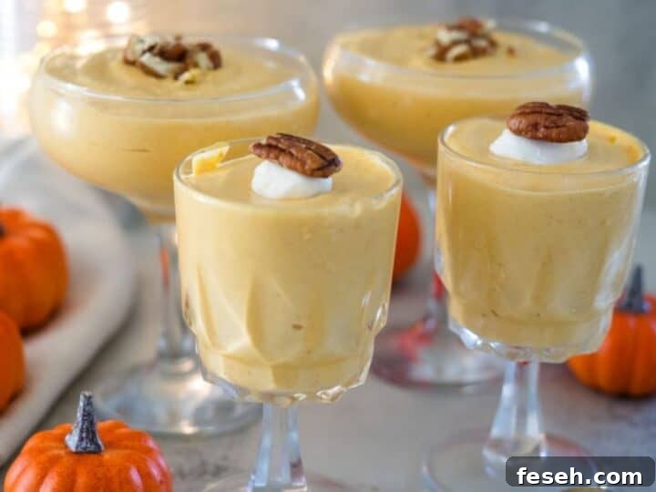 Three glasses of pumpkin mousse with pecans.