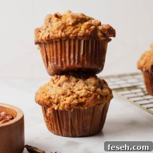 pumpkin banana bread muffins with streusel topping on a white board.