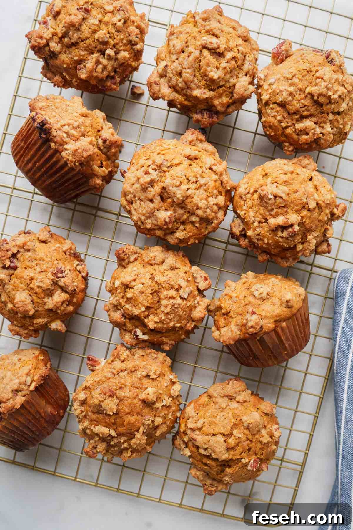 pumpkin banana bread muffins with streusel topping on a baking rack.