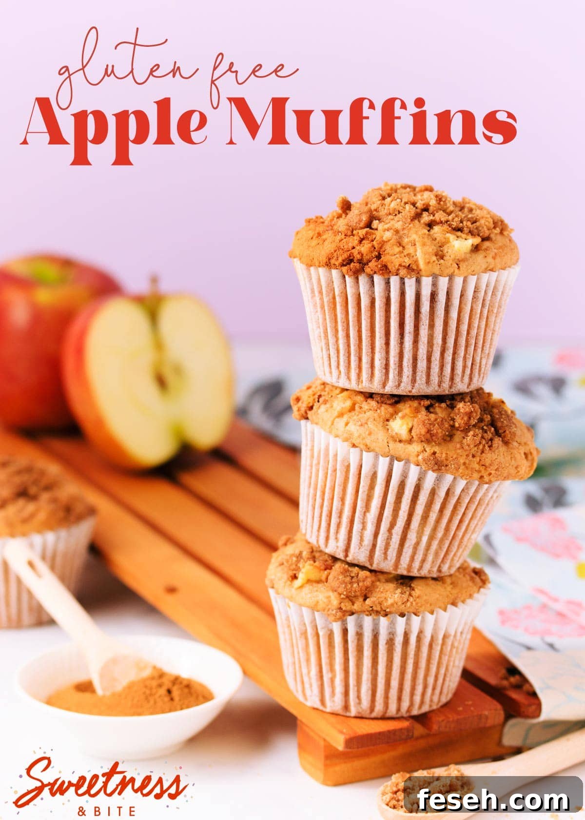 Three muffins stacked on top of each other, on a wooden board, with an apple and small dish of cinnamon in the background, text overlay reads "gluten free apple muffins".