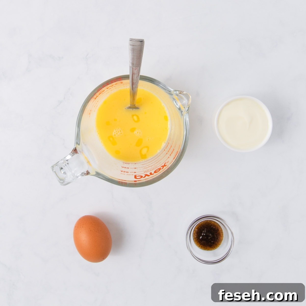 The melted butter and milk in a glass jug.