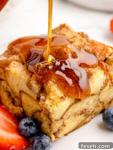 A square of French toast drizzled with maple syrup.