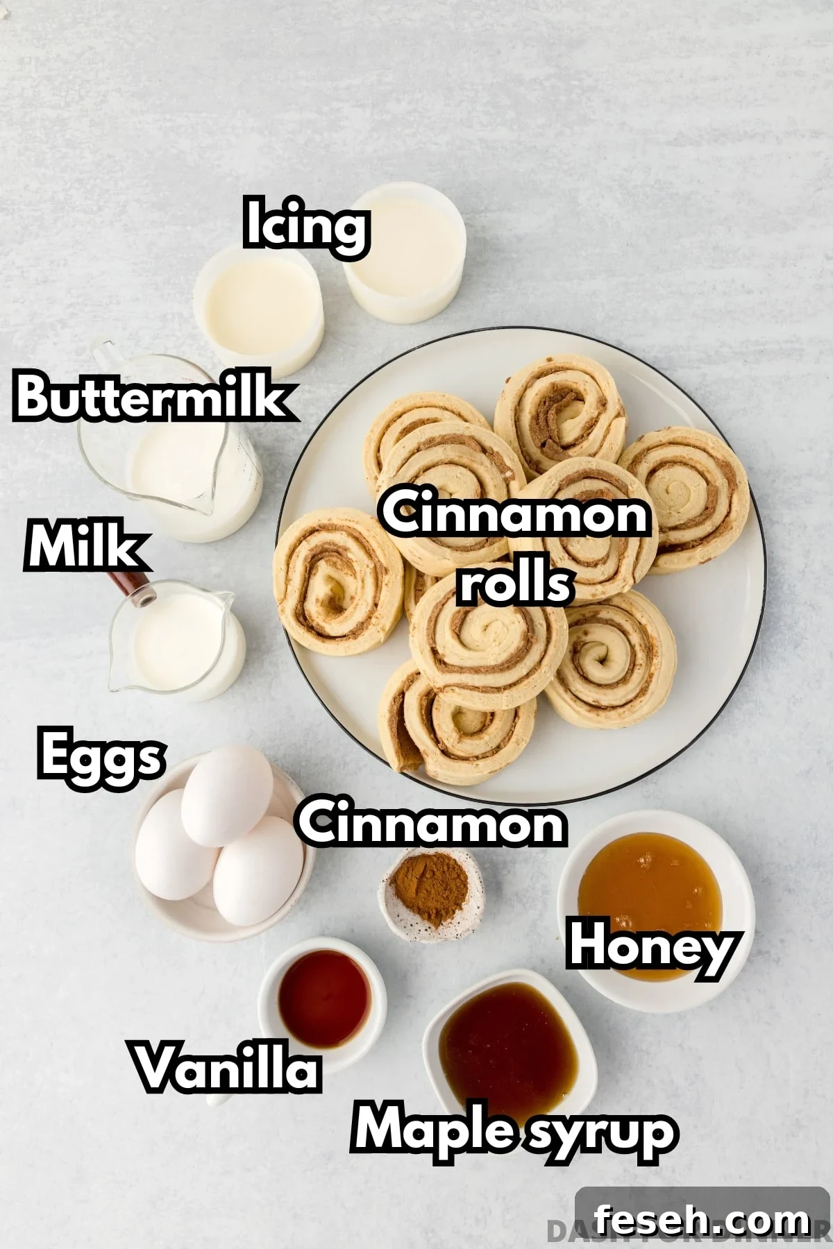The ingredients needed to make cinnamon roll casserole: refrigerated rolls, maple syrup, honey, milk, eggs, etc.