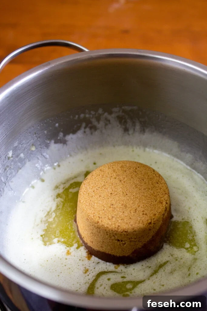 Caramel being poured over crackers