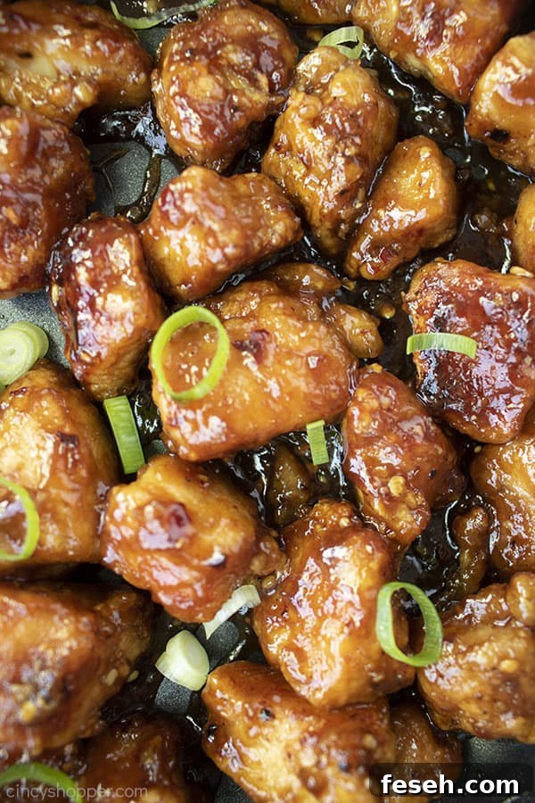Closeup of sticky General Tso's Chicken in a pan.