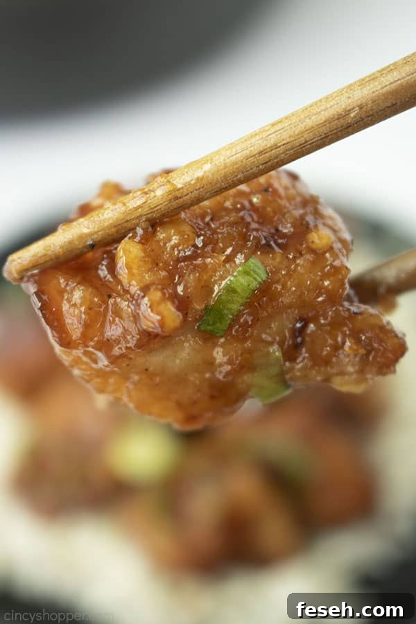 General Tso's Chicken between two chopsticks.