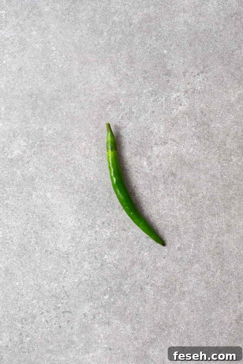 A single green finger chilli.