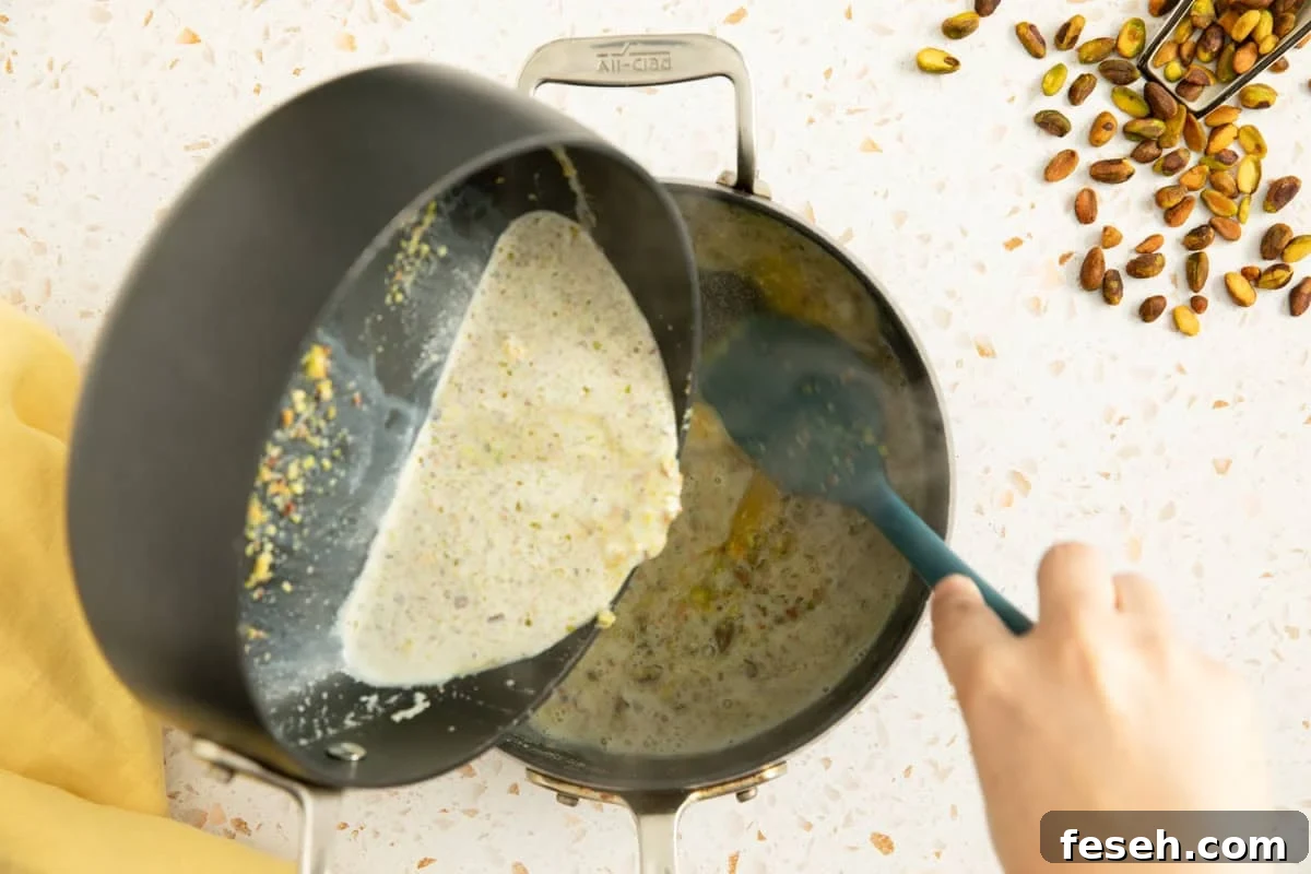 Milk being poured into egg and sugar to make a custard ice cream base