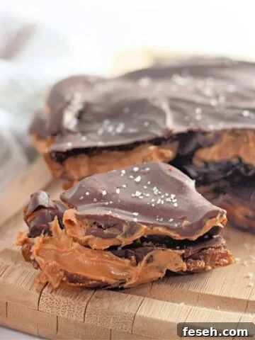 Peanut butter chocolate date bark on top of a wooden board.