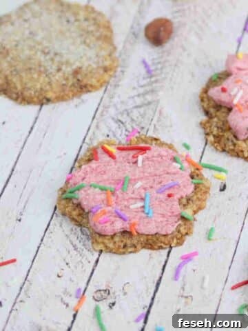 Sugar cookies with pink icing and sprinkles.