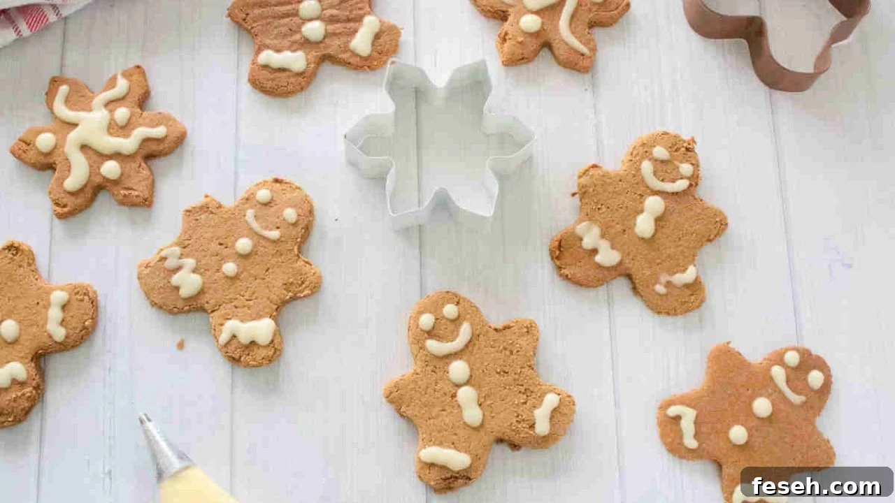 High protein gingerbread cookies with frosting and a cookie cutter in the middle.