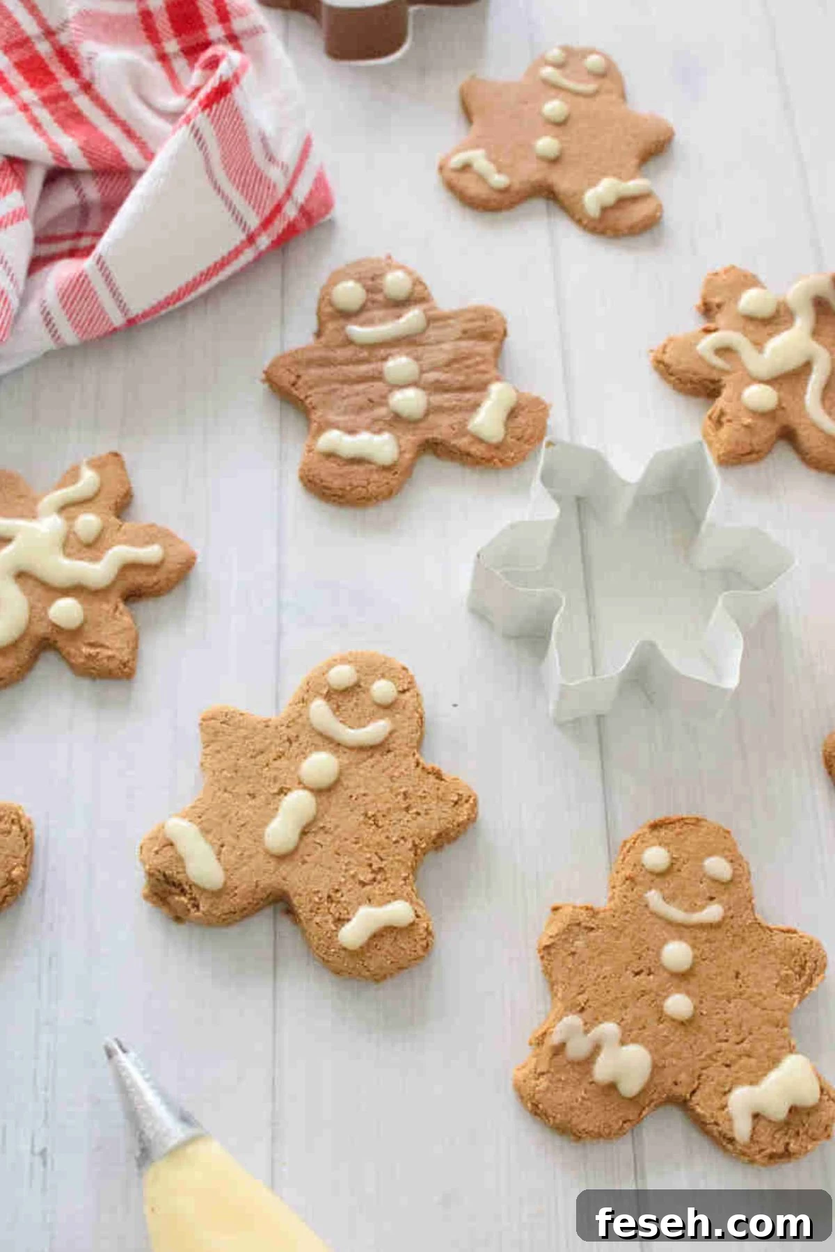 High protein gingerbread cookies with frosting and a cookie cutter in the middle.