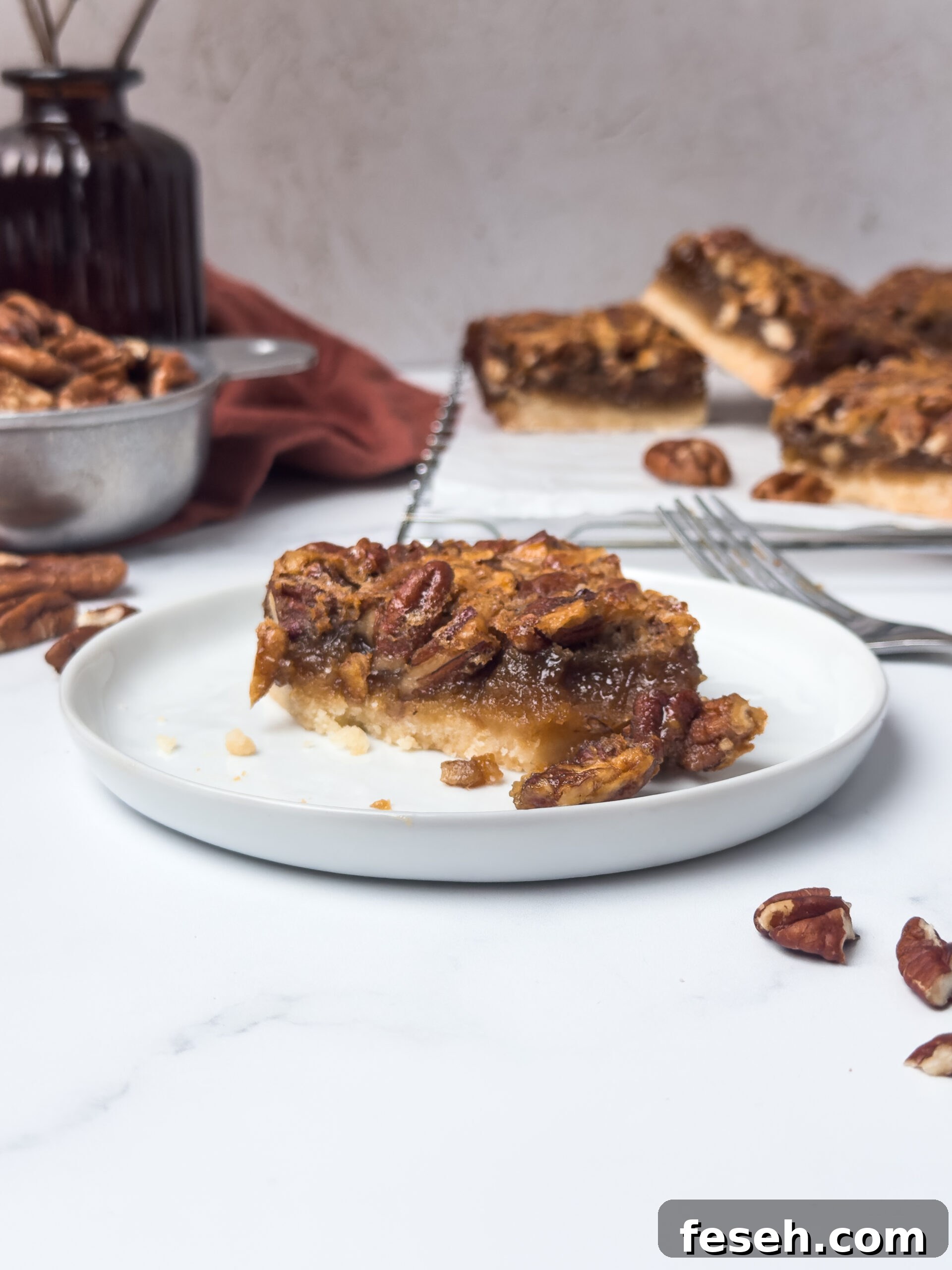 Slices of pecan pie bars on a plate