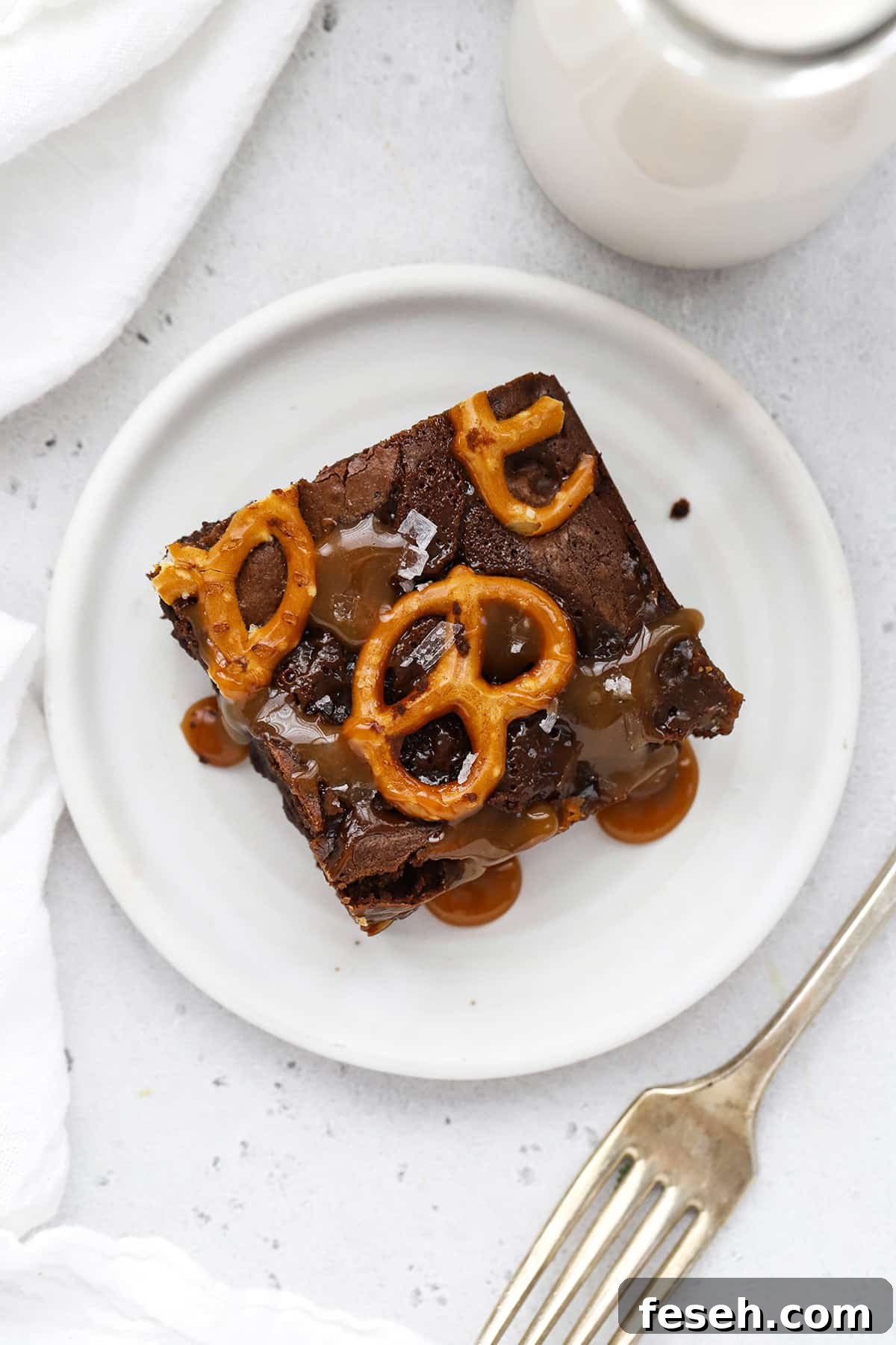 A gluten-free caramel pretzel brownie on a plate