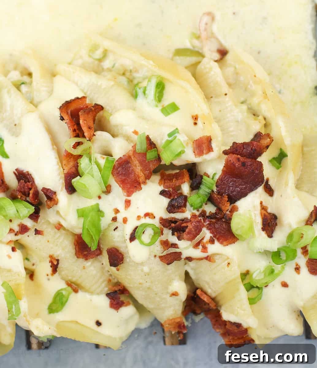 prepared recipe in bake dish, fresh from the oven topped with green onion and bacon