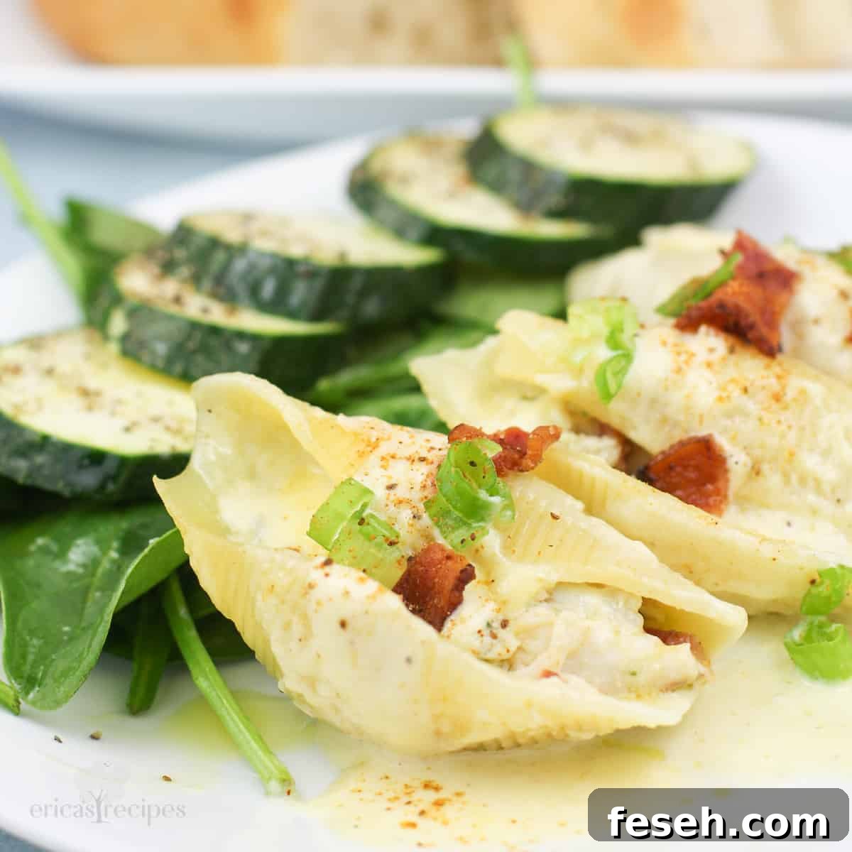 three crab stuffed shells on white plate with salad