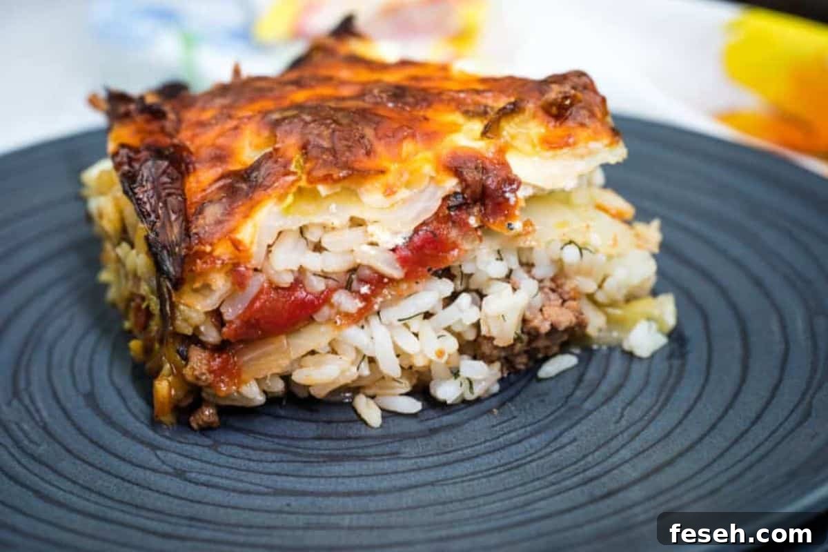 17 Pantry-Friendly Nanna Casseroles That Taste Homemade and Luxurious 2 A slice of layered cabbage roll casserole served on a dark plate.