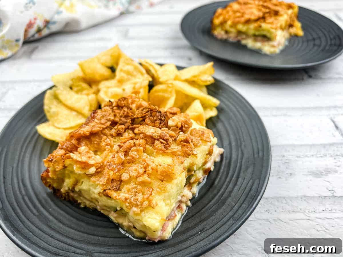 17 Pantry-Friendly Nanna Casseroles That Taste Homemade and Luxurious 14 A piece of Cuban sandwich casserole on a plate with potato chips.