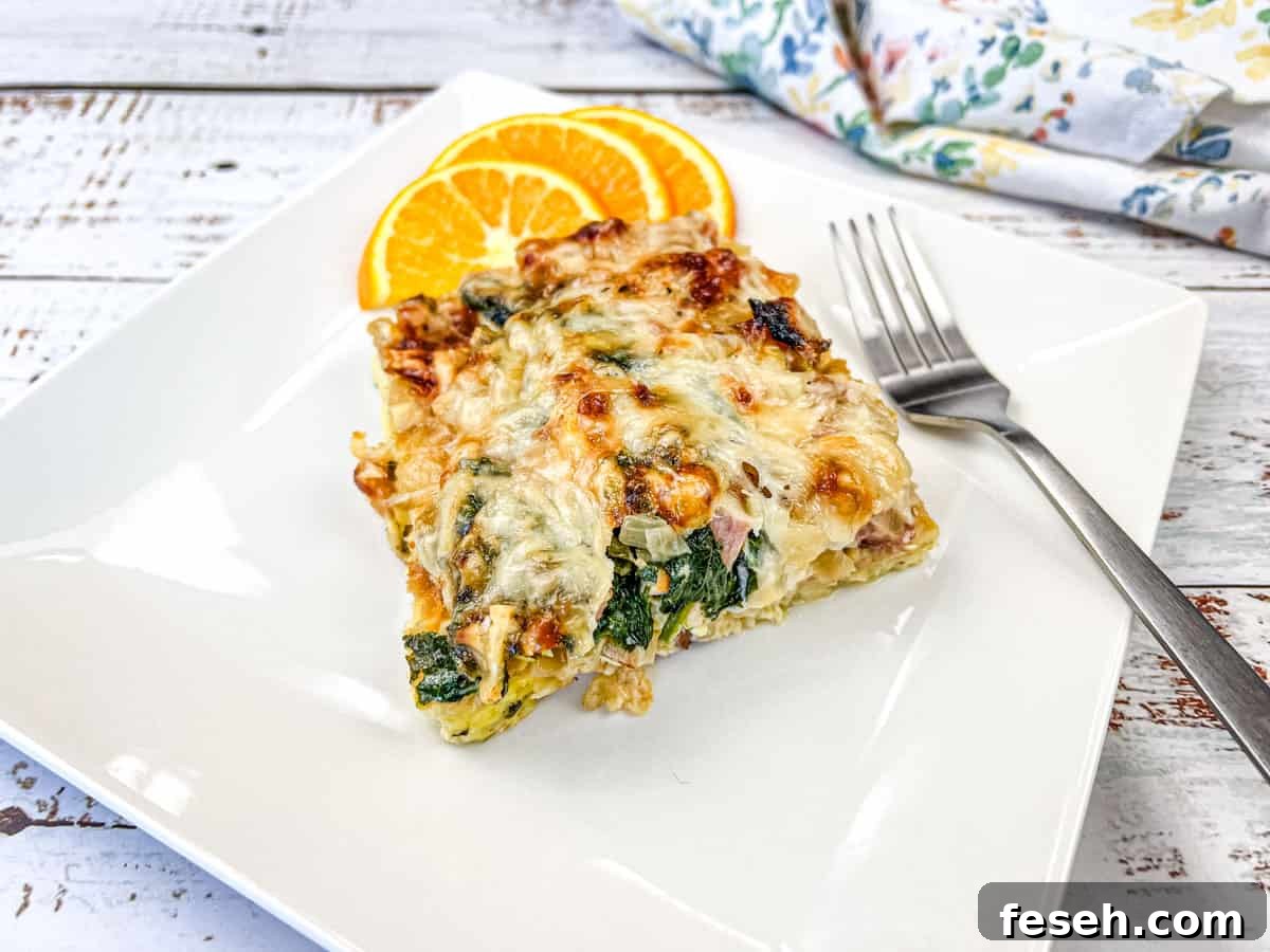 17 Pantry-Friendly Nanna Casseroles That Taste Homemade and Luxurious 18 A white plate with a slice of Croissant breakfast casserole and orange next to it.