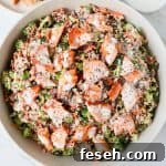 Broccoli quinoa salad with salmon on top.