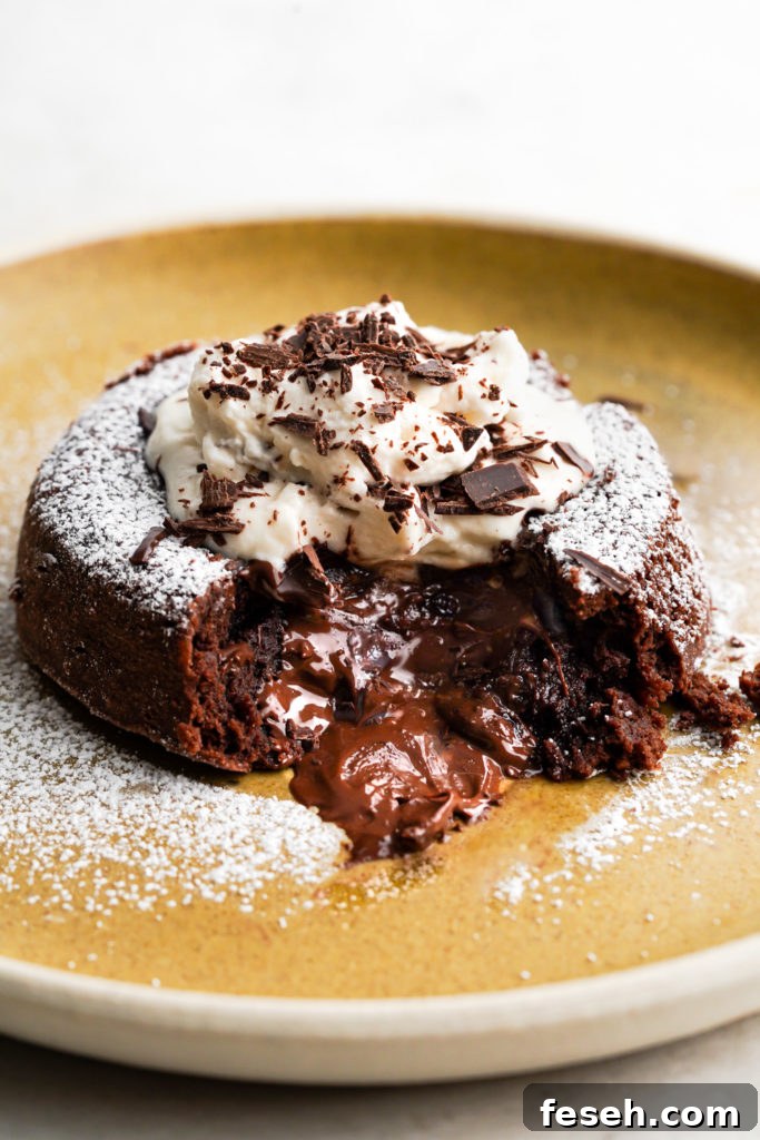 Plated chocolate lava cake with the center exposed to reveal a fudgy center