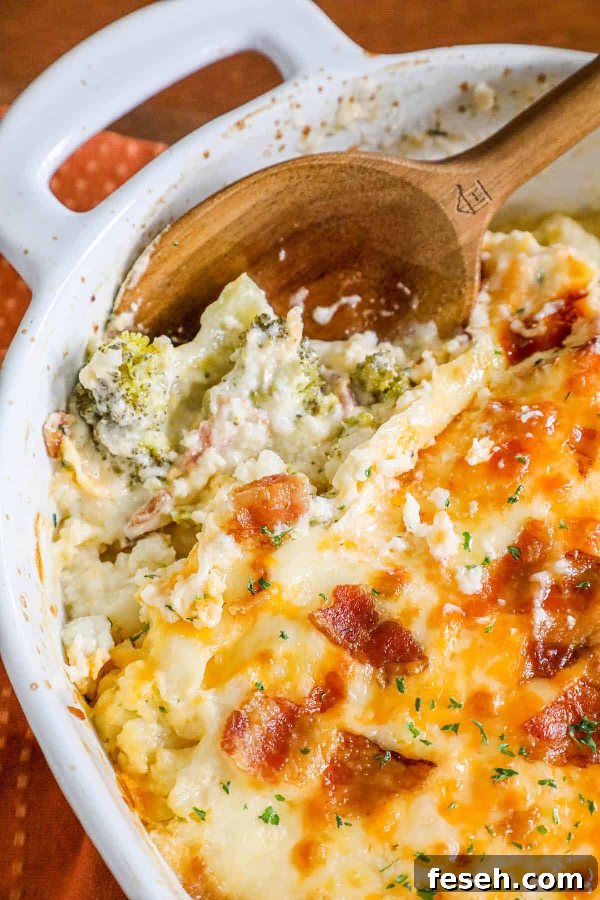 A broccoli casserole dish with cheese and bacon.