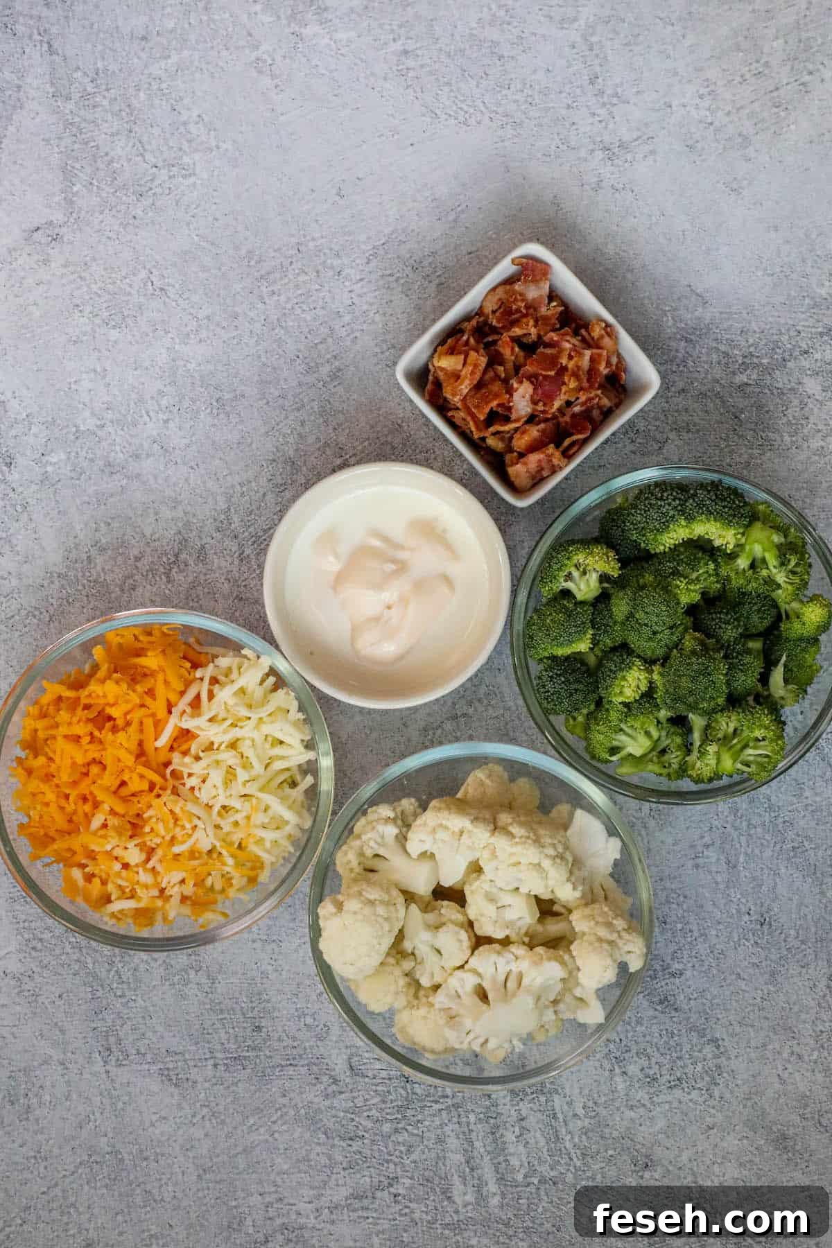 Four bowls containing broccoli, cheese, and bacon casserole.